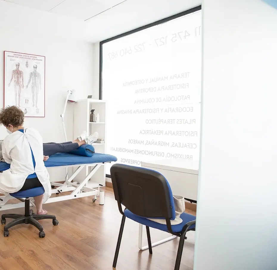 Fisioterapeuta tratando a un paciente en la camilla de una de las consultas